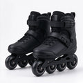 Matte black skates standing on a dark studio floor