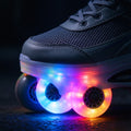 Black sneaker-style skates with rainbow LED wheels at dusk